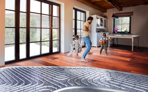 A father and toddler children playing indoors at home.
