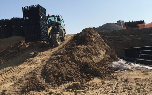 A forklift carrying Stormbox E soakaway crates | Pipelife